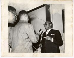 President William V. S. Tubman talks with man with cigar