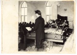 Man reads from podium at funeral service