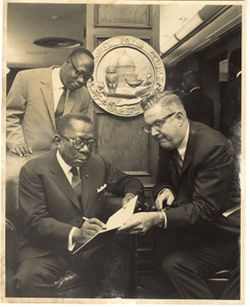 President William V. S. Tubman signs book with National Press Club seal hanging in background