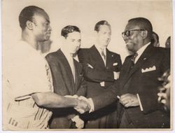 President Tubman shaking hands with man in traditional garb