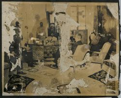 President Tubman seated behind a desk with other dignitaries seated around the room