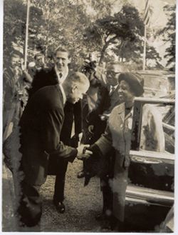 President William V. S. Tubman and Mrs. Tubman exit vehicle while shaking hands with man