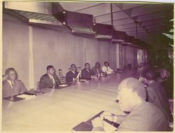 President Tubman using handkerchief at conference table