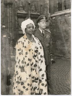 Mrs. Tubman in formal dress and man in miliary dress walk together