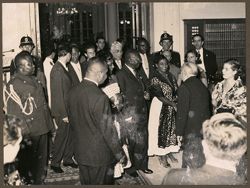 President and Mrs. Tubman at a reception, Mrs. Tubman shakes a dignitary's hand