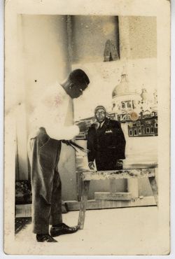 Man painting picture of man outside domed building