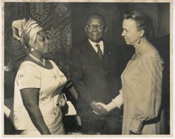 President William V. S. shakes hands with woman
