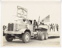 Raymond-Utah "Builders for a better Liberia" truck pulling men waving American flag