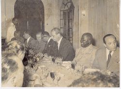 Candid photo of men at formal dining table