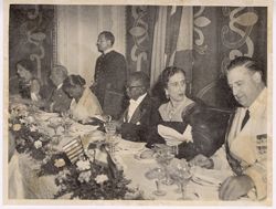 President Tubman examines menu as Carmen Polo speaks with dinner guest