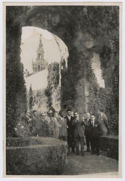 President Tubman and a group of dignitaries stand in an archway with the Seville Cathedral in the background