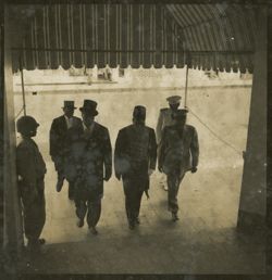 Men walk together under awning