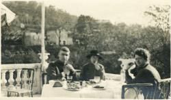 Three people at the restaurant building seen in image VAE4199-000244