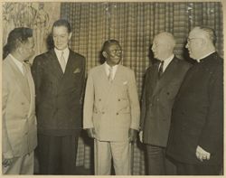 Ambassador Simpson stands with President William V. S. Tubman and others