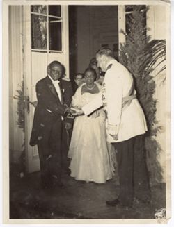 President Tubman shaking hands with man in military regalia