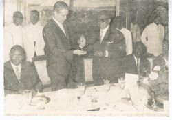 President William V. S. Tubman hands official chain
