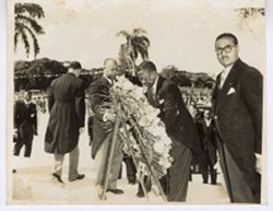 President William V. S. Tubman attends to memorial wreath as gathering disperses