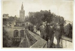 President Tubman and other dignitaries on an elevated walkway with the Seville Cathedral in the background