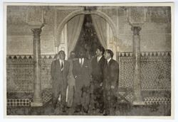 President Tubman stands with dignitaries in a ornately tiled room