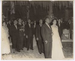 President Tubman escorts a woman in a ballroom