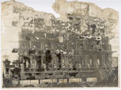 Large machinery with person standing above in rafters