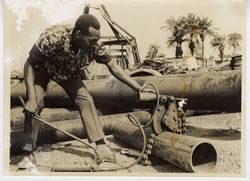 Man works on pipes at a construction site