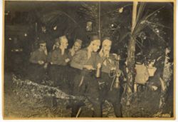 Men in traditional dress walk together in a line