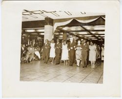 Group walking together, arm in arm, into reception