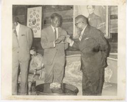 President William V. S. Tubman toasts with a guest in a sitting room