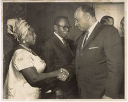 Mrs. Tubman shakes hand of man in receving line with President William V. S. Tubman in background