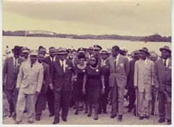 Group of people walking with President Tubman