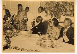President William V. S. Tubman seated at a formal dinner with other dignitaries
