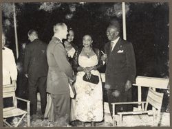 President and Mrs. Tubman talk to a military official