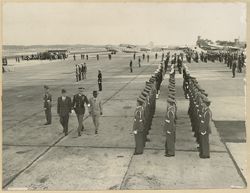 President William V. S. Tubman and Richard Nixon walks with military officials on run way past military formation