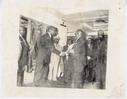 Officials greet each other in entrance way