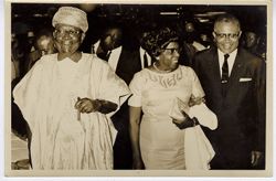 President William V. S. Tubman in traditional dress walks with guests during celebration