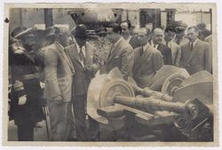 President Tubman takes a closer look at machine parts