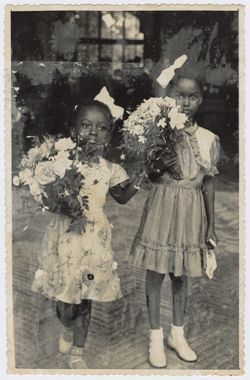 President Tubman's daughter and friend Banke King hold flowers