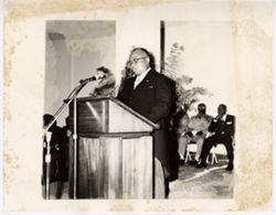 Vice President Tolbert stands at podium