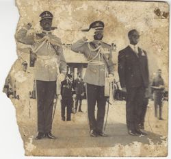 Men in military attire saluting towards camera