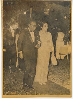 President William V. S. Tubman and young woman walk arm and arm