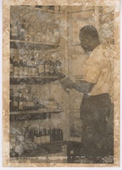 Man inspecting showcase of liquor bottles