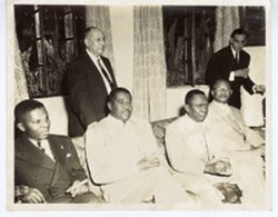 President William V. S. Tubman, Paul Magloire, Ambassador Brewer, and reception guests pose for the camera
