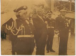 President Tubman in military regalia standing with officers
