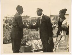 Ambassador C. T. O. King shakes hands with man