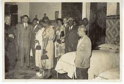 President Tubman and other dignitaries on a tour of a dormitory in or near Seville, Spain