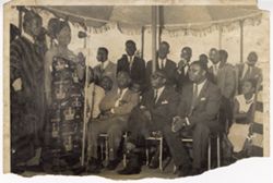 Dignitary speaks into a microphone, addressing a crowd that includes President William V. S. Tubman