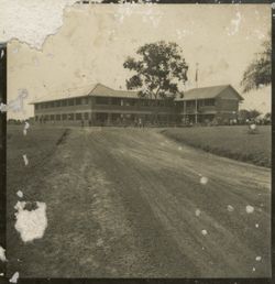 Exterior shot of large building with crowd around