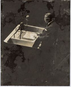 President William V. S. Tubman stands at podium at speaking engagement