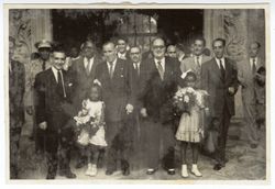 President William V. S. Tubman stands with Spanish officials, his daughter, Coocoo, and friend Banke King at the entrance of a building in or near Seville, Spain